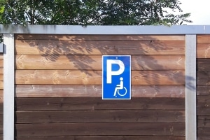 Parken mit Behinderung: Ein Behindertenparkplatzschild ist gut an dem Rollstuhlfahrer-Symbol zu erkennen.